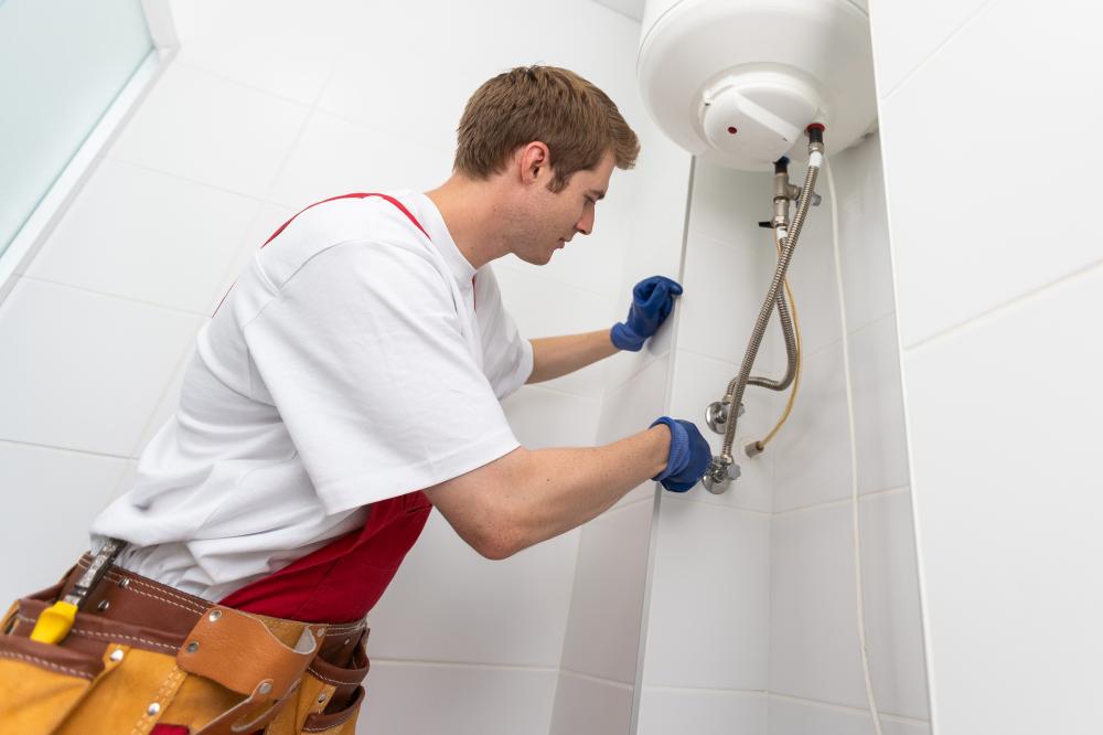 Closeup of a plumber fixing a boiler, representing quality shower installation in Portsmouth