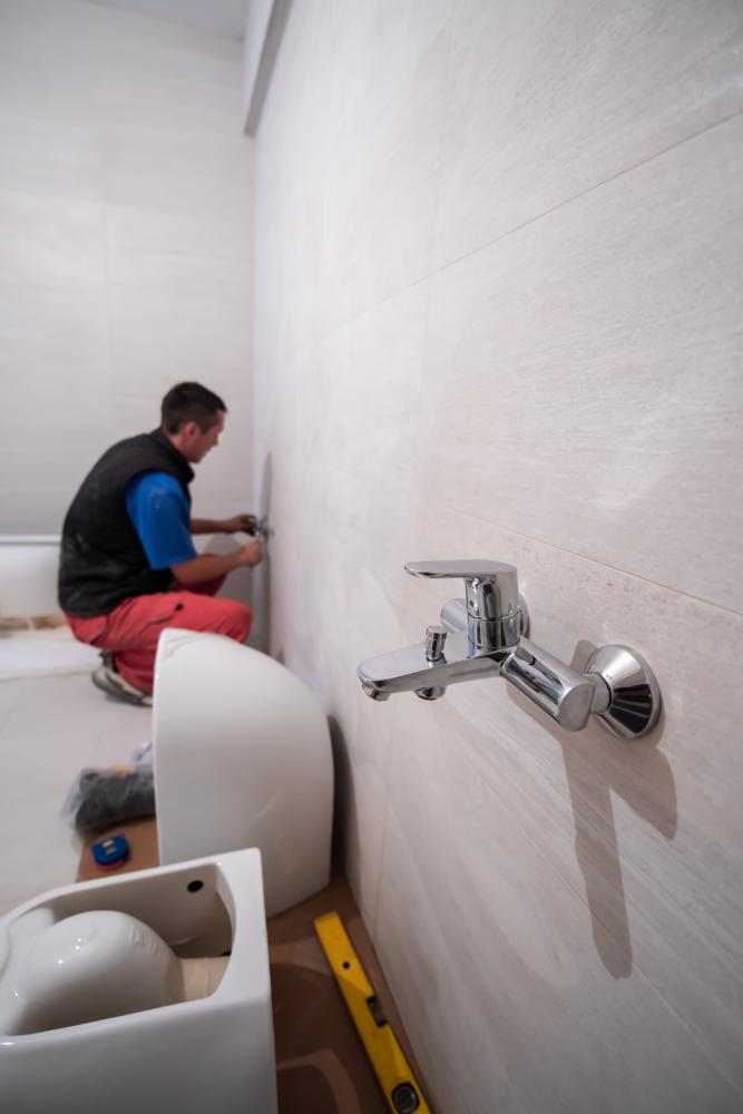Professional Chesapeake Plumber working on bathroom plumbing