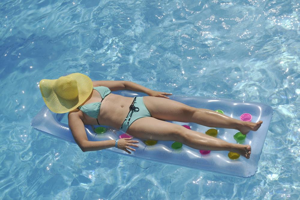 Woman enjoying the benefits of solar-heated swimming pool in Palm Coast