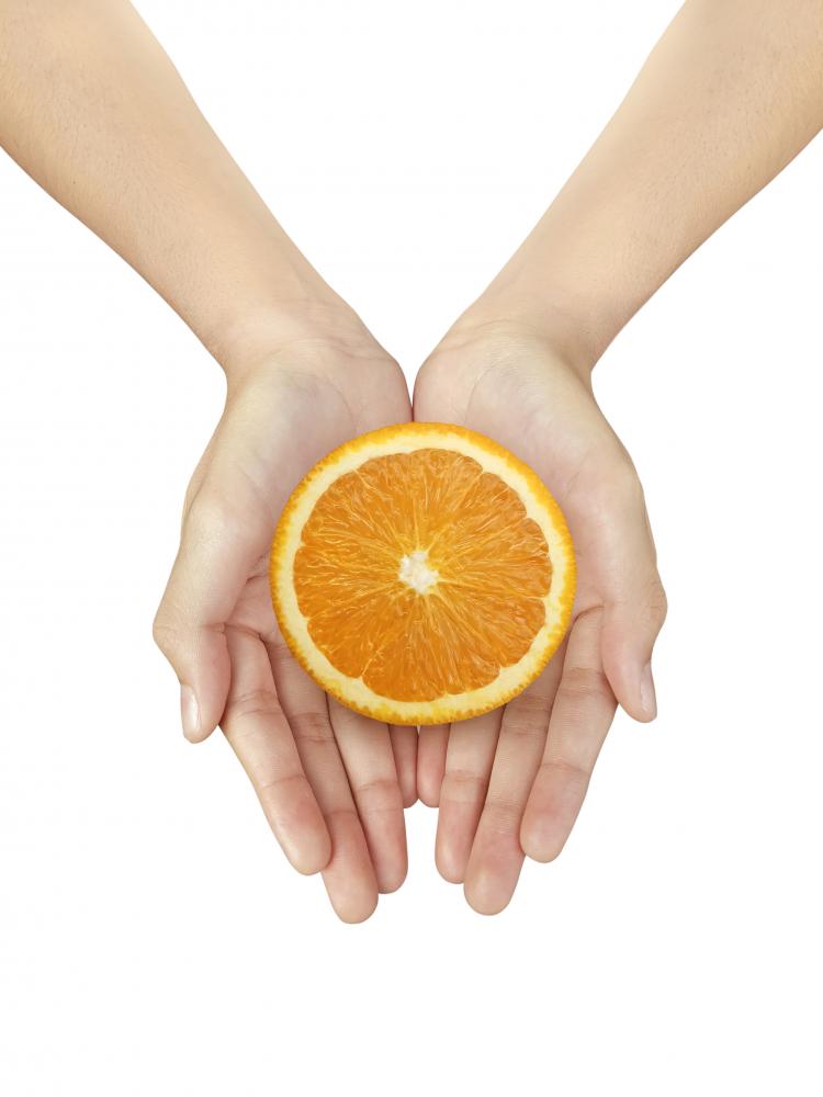 Woman holding a bright orange slice, symbolizing rejuvenation