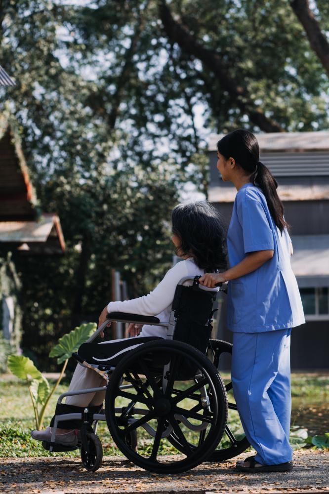 Caring home health aide ensuring patient comfort at home