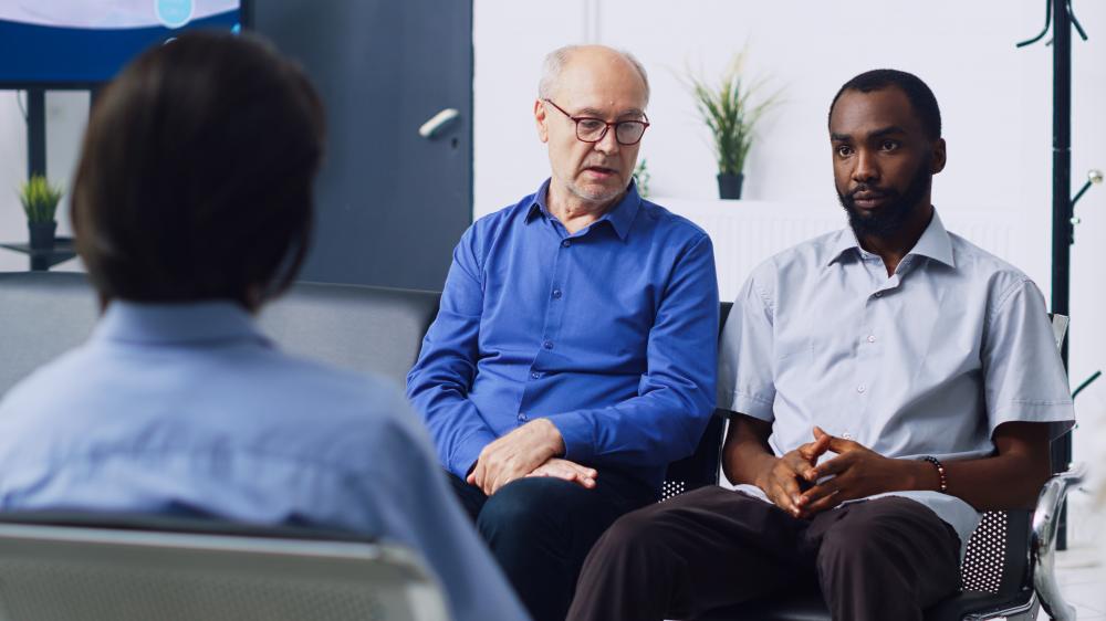 Group of men in an IOP session discussing recovery in California