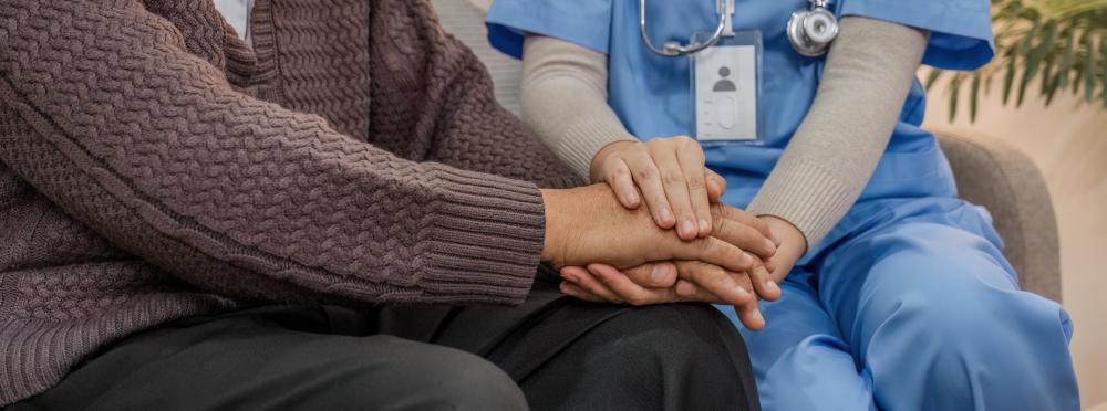 Patient holding hands with caregiver symbolizing support in recovery
