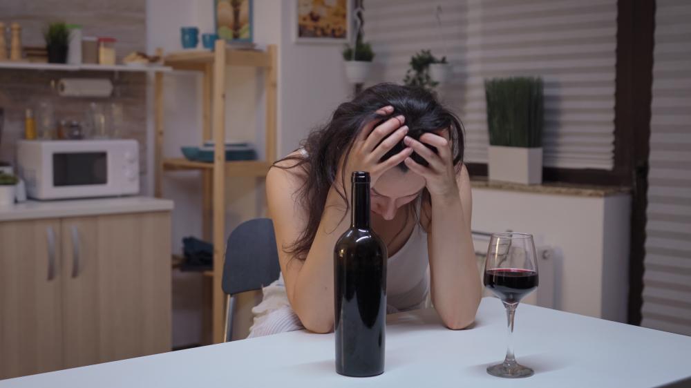 Reflective image of a lonely individual grappling with alcohol addiction