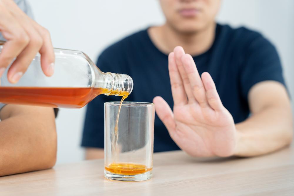 Man refusing alcohol illustrating the resolve to overcome addiction