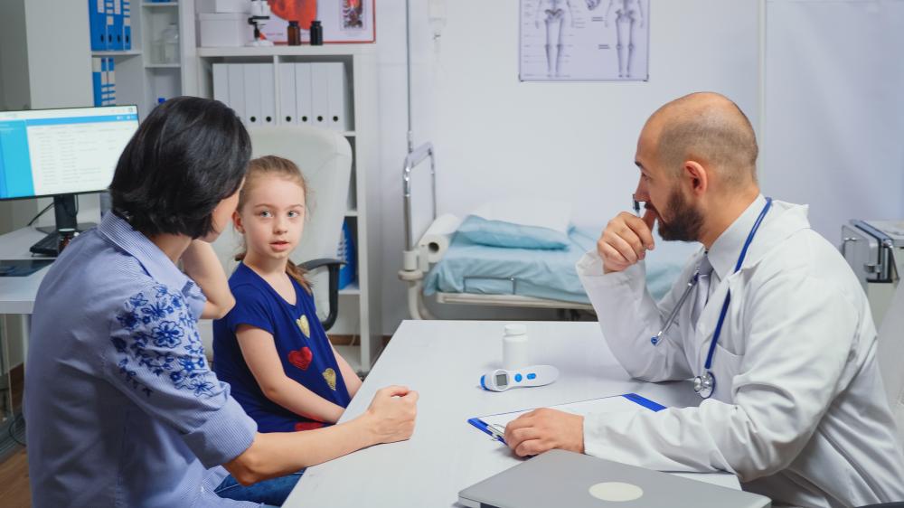 Healthcare professional formulating a treatment plan for a child with dual diagnosis