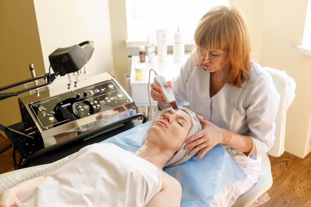 Cosmetologist performing ultrasonic face therapy, related to holistic RF Therapy experiences