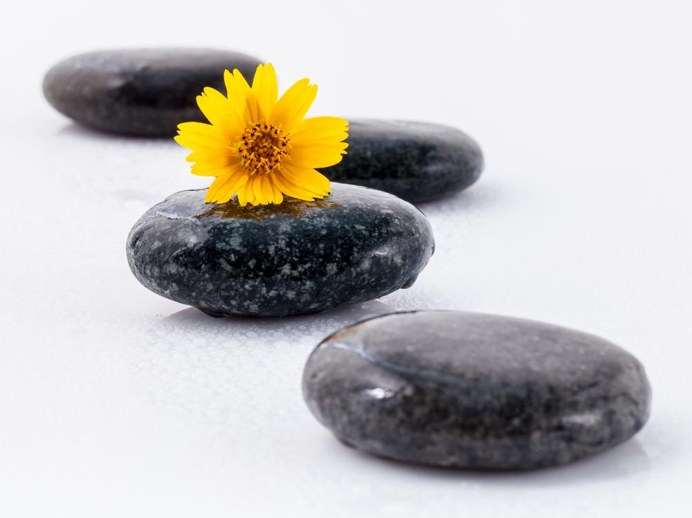 Harmonious balance with yellow flower and stones emphasizing holistic healing