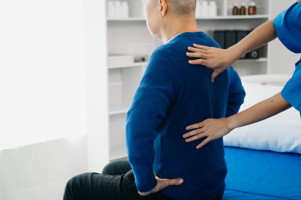 Chiropractor consulting with patient about back problems