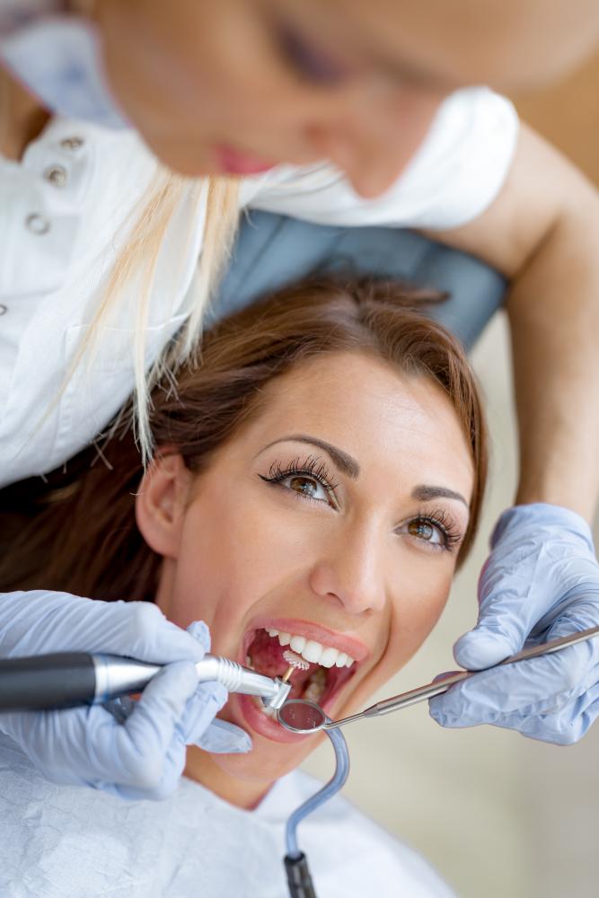 Smiling female dentist ready to enhance your oral health