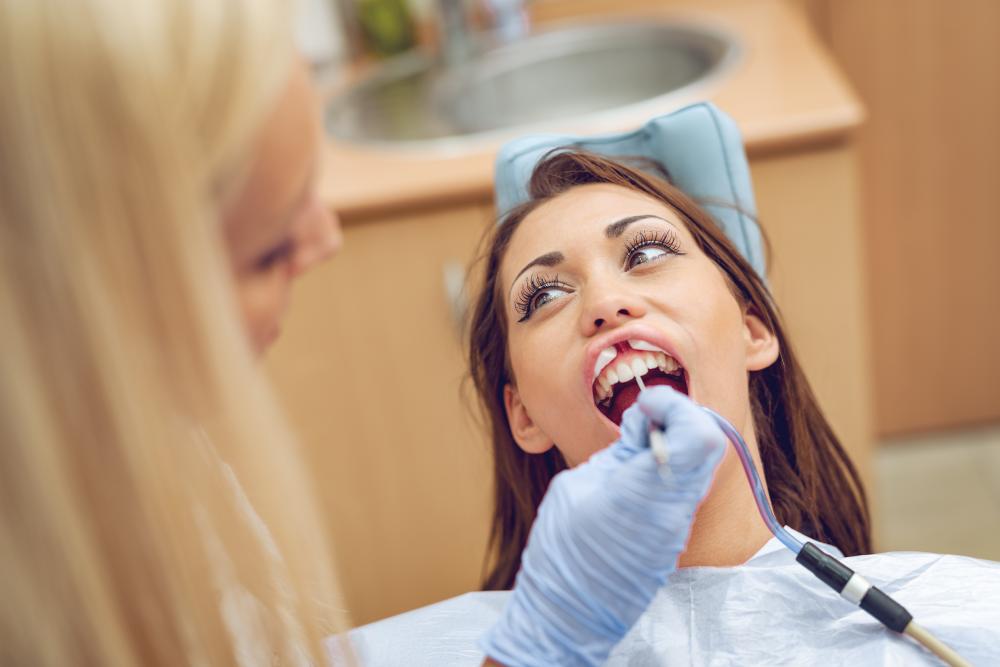 Dentist preparing patient for tooth whitening indicating expert oral care