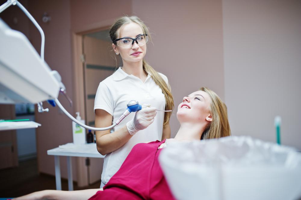 Dentist showcasing dental implant models for patient education