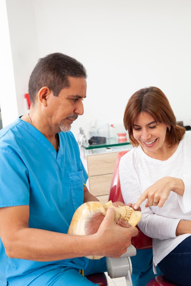 Dentist explaining post-appointment care to a patient