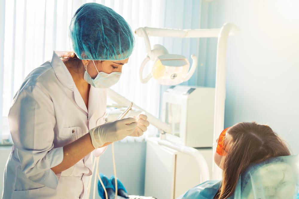 Young female dentist attending to patient during urgent dental care
