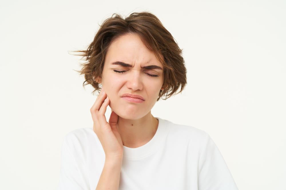 Woman managing toothache emergency waiting for dental care