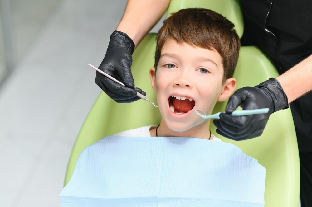 Pediatric dentist examining a young patient's teeth