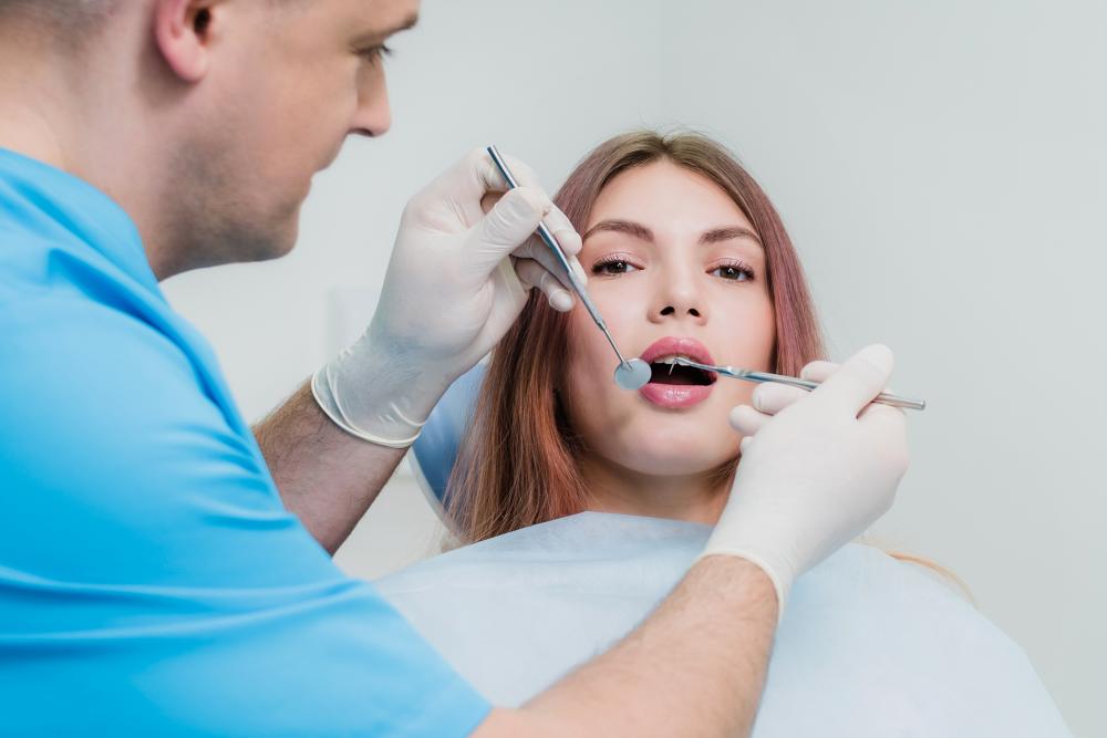 Orthodontist Examining Patient's Teeth at Redstone Smiles Dental