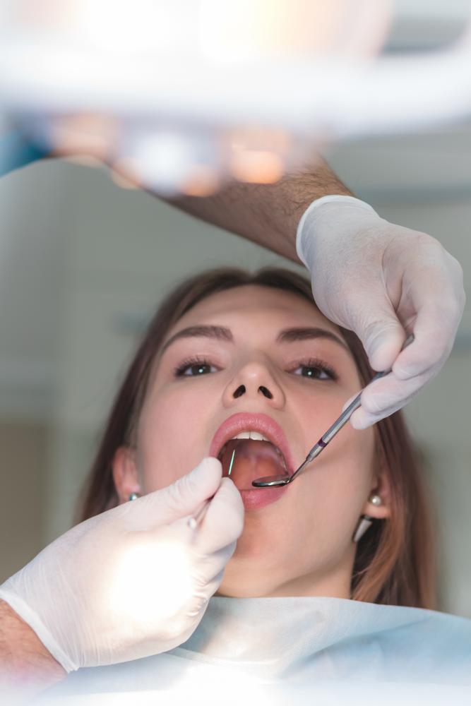 Orthodontist examining the oral cavity of a patient illustrating dental assessment