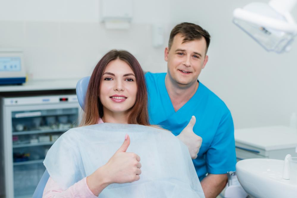 Orthodontist and patient smiling in an Edmonton dental clinic