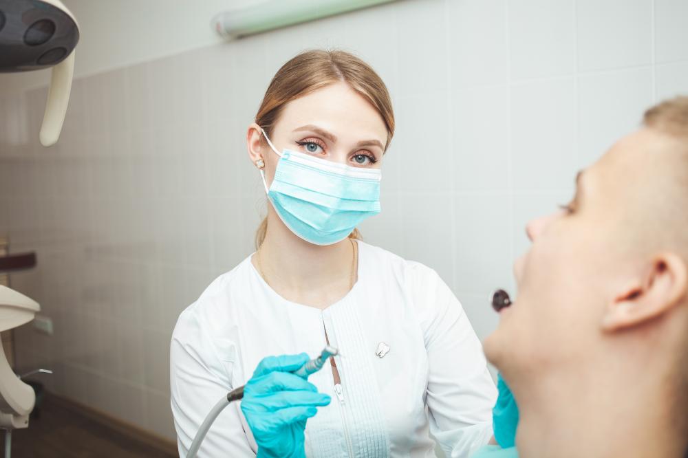 Skilled European female dentist ready to check patient's oral health