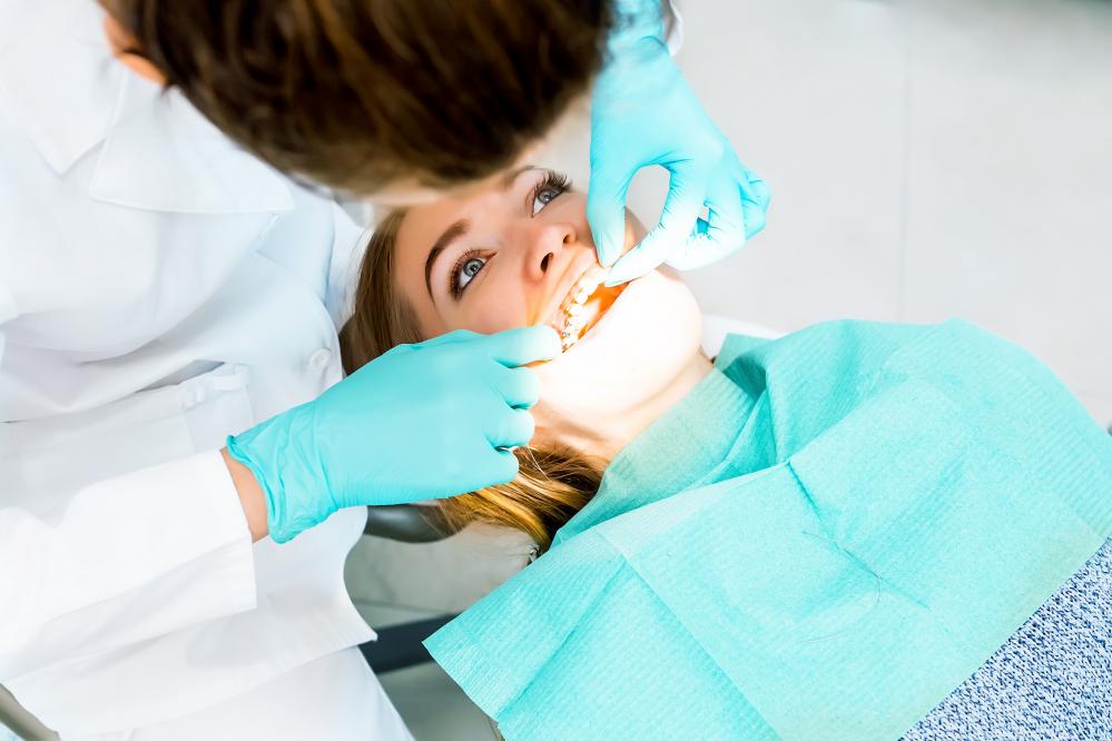 Dentist providing urgent care to patient with braces in South Calgary