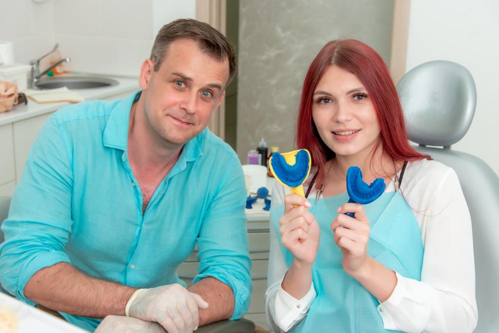 Friendly orthodontist with satisfied patient showcasing dental health