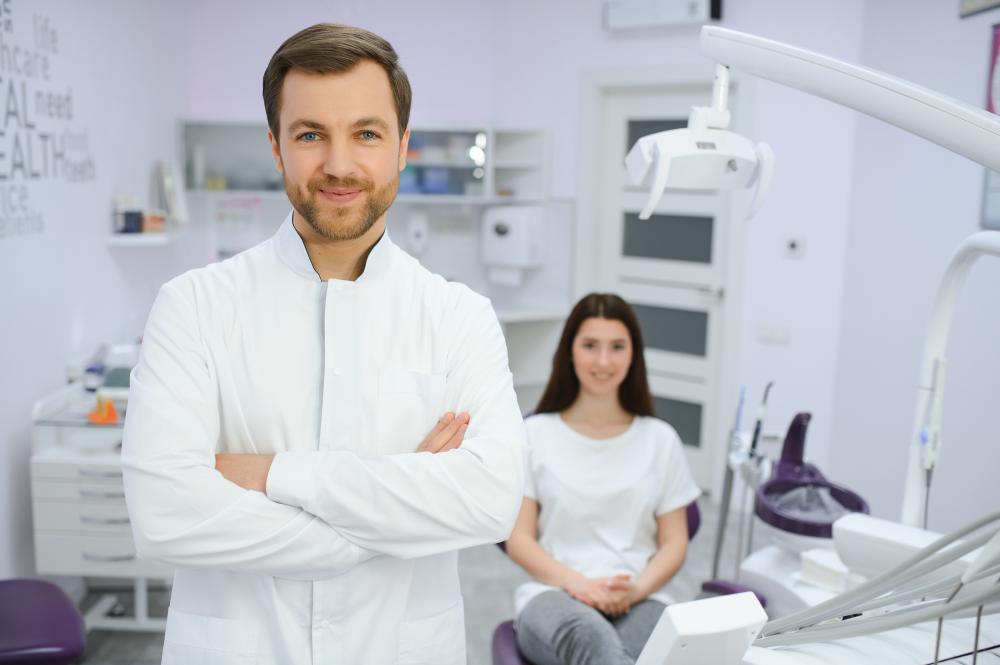 Dentist showcasing patient's smile transformation