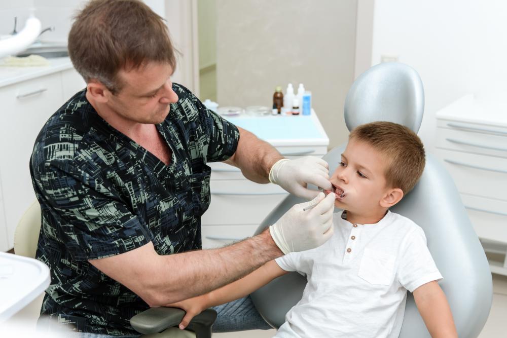 Orthodontist checking child's teeth depicting Sunday dental services