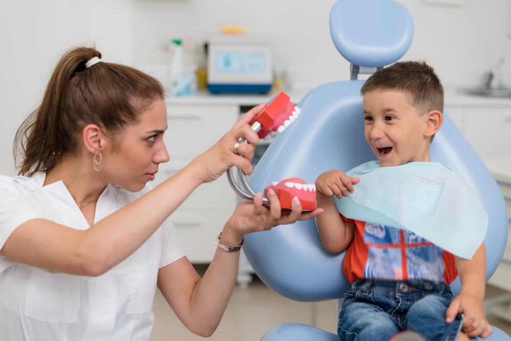 Orthodontist engaging with a child patient during dental appointment