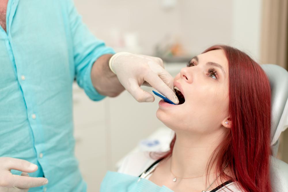 Orthodontist demonstrating impression tray to patient at NE Calgary Restorative Dentist