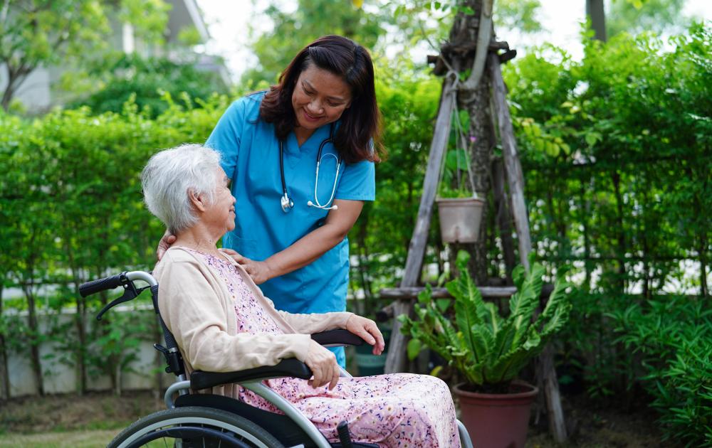 Compassionate home health care aide assisting elderly woman in Brooklyn, NY