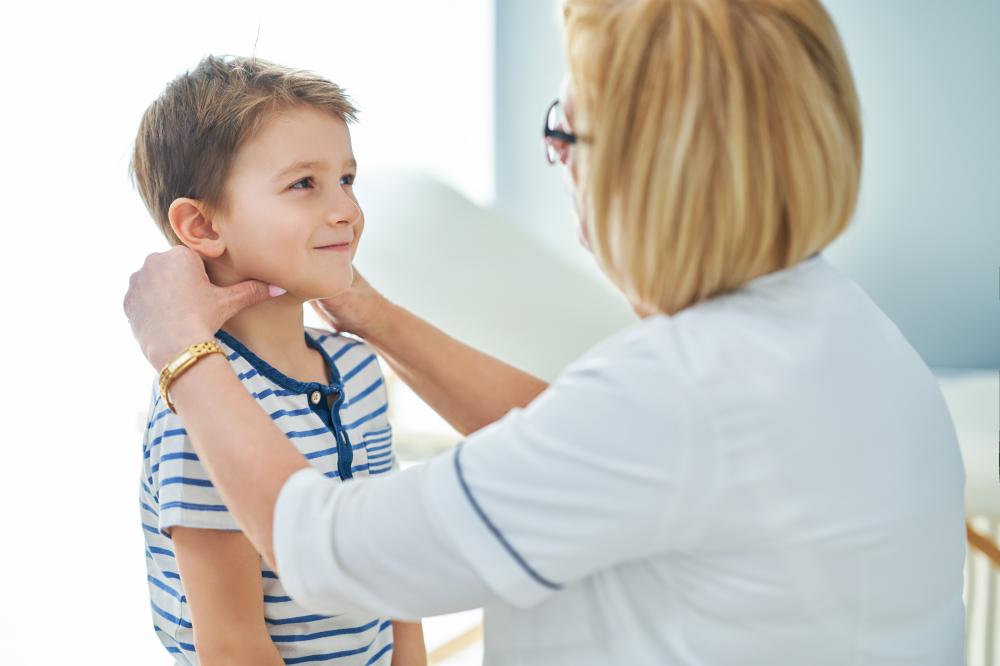Pediatric doctor consulting with a child about esophageal conditions