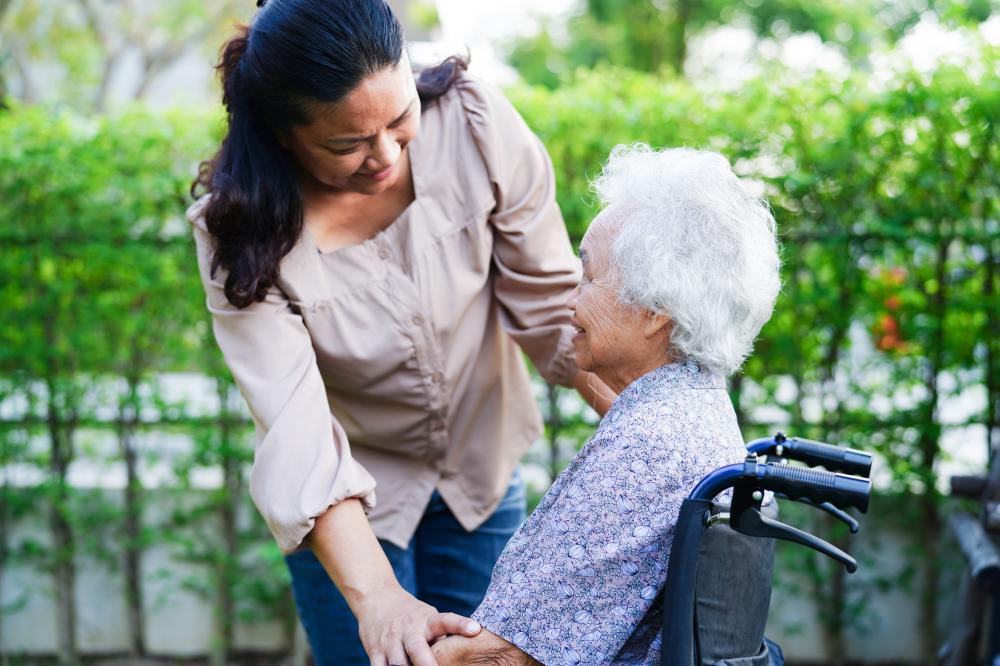 Caring home care professional assisting an elderly woman in Manhattan