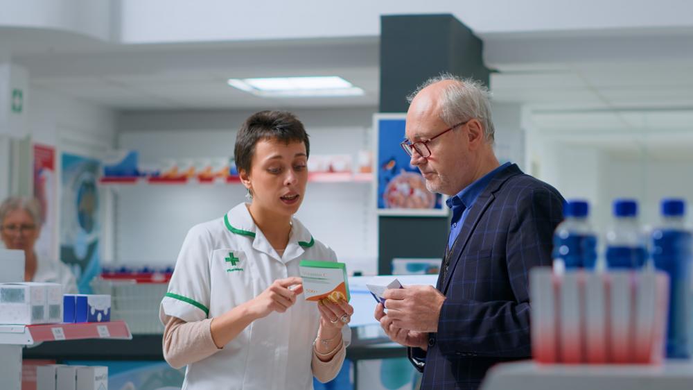 Elderly shopper deciding on healthcare products at CurisRx Pharmacy