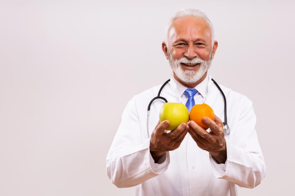 Senior doctor promoting prostate cancer nutrition with fruits