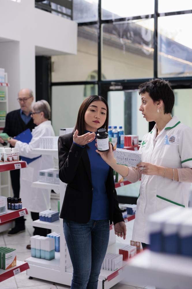 Attentive pharmacist assisting with product returns at CurisRx Pharmacy