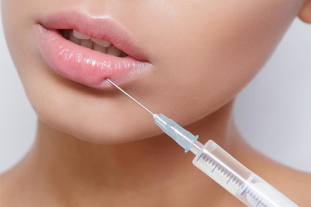 Woman receiving professional lip injection at Benson Aesthetics