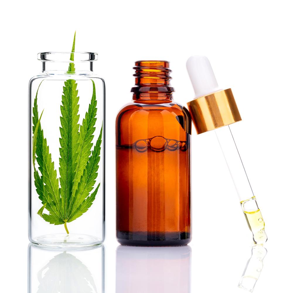 Green hemp leaves with CBD oil bottle highlighting alternative healing options