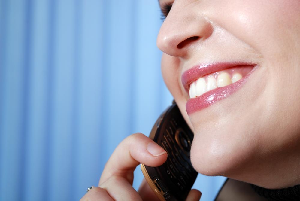 Businesswoman with cellphone representing dental answering service