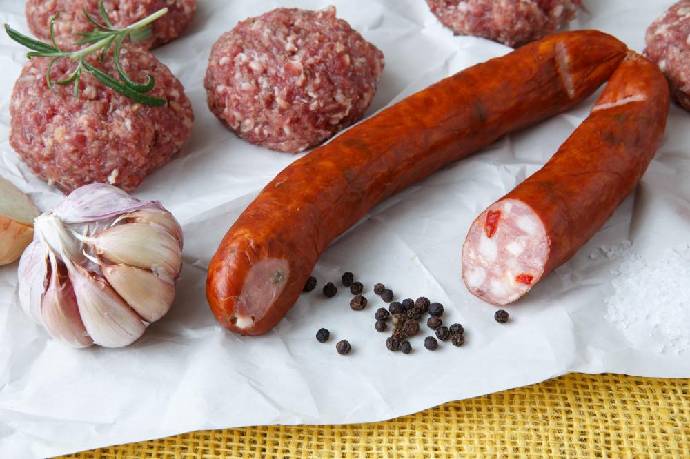 Raw minced meat and sausage with seasonings ready for cooking