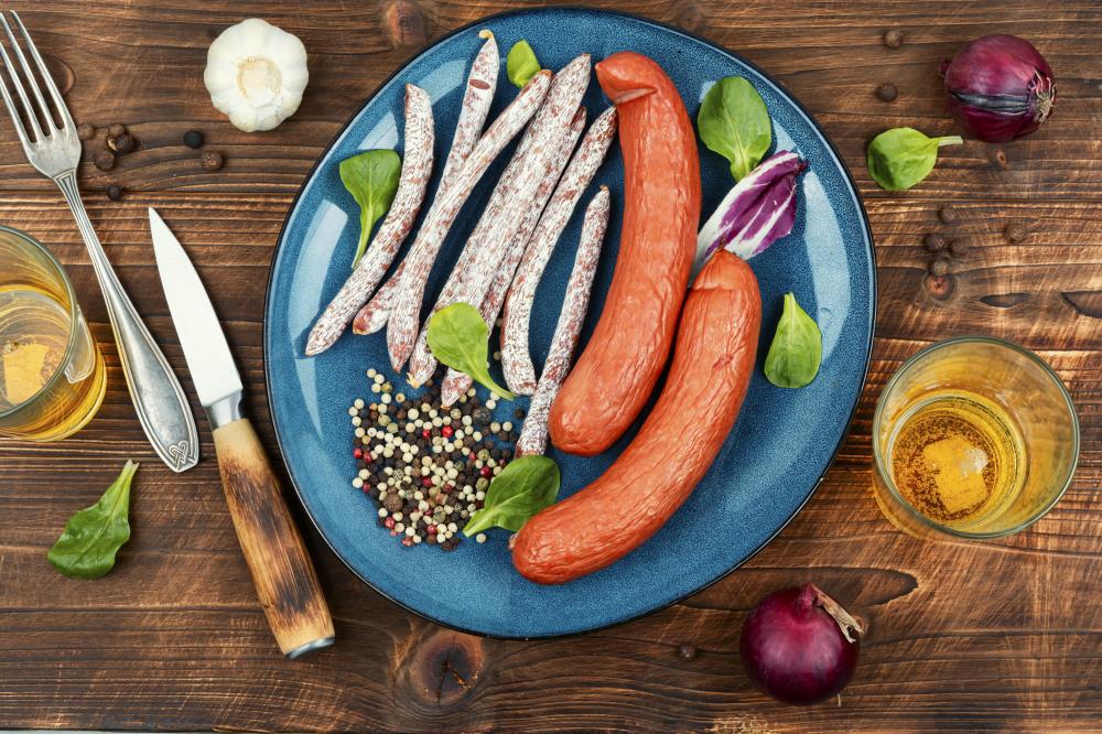 Thin kabanos sausages on a rustic wooden background