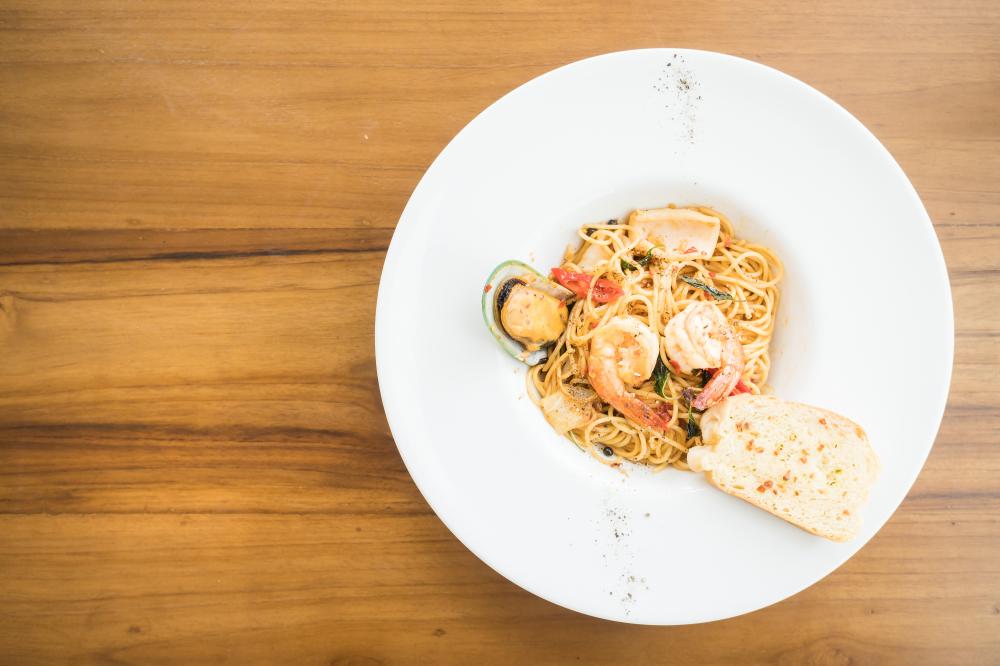 Authentic Seafood Spaghetti on White Plate Embodying Coastal Italian Cuisine in San Antonio