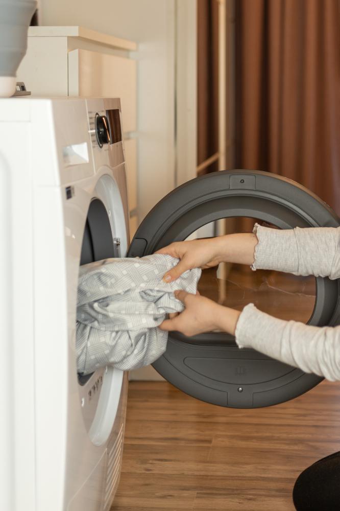 vecteezy person loading laundry into washing machine in a modern home 59944543 496