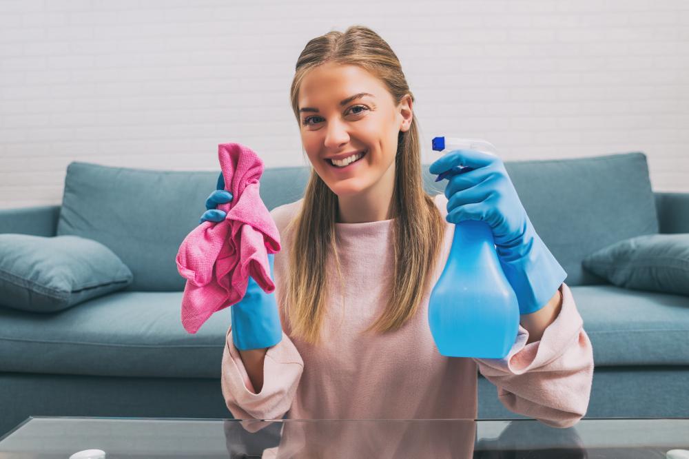 Happy woman effectively cleaning modern workspace