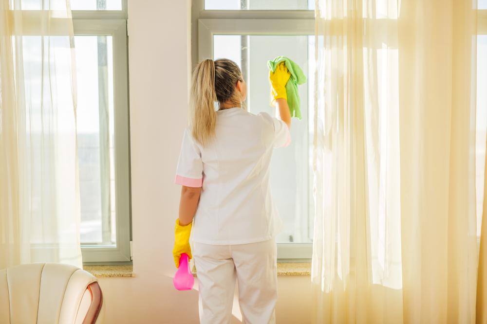 Hotel maid providing exceptional window cleaning service