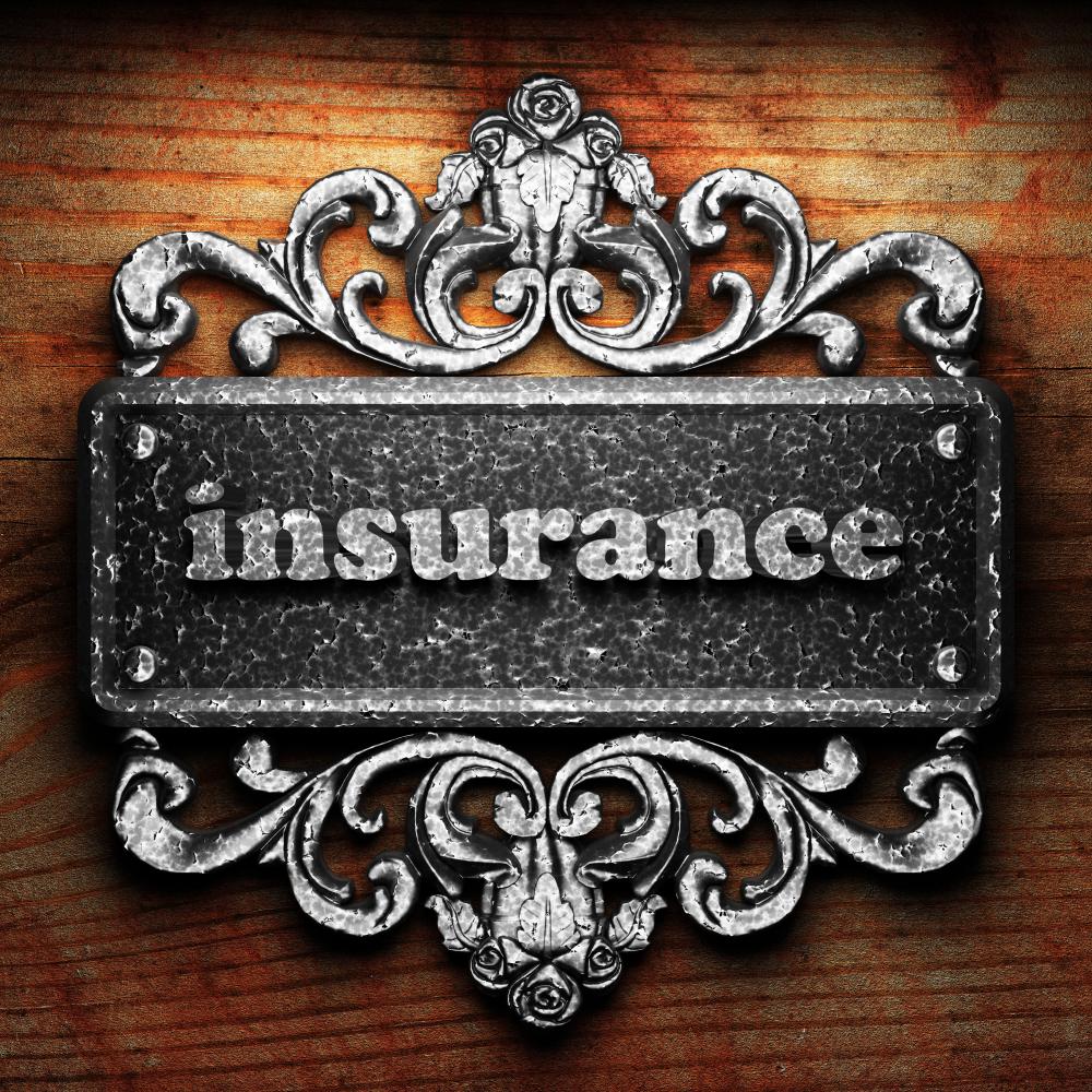 The word 'Insurance' spelled in iron on a wooden background, representing the foundation of Renters Insurance Toronto