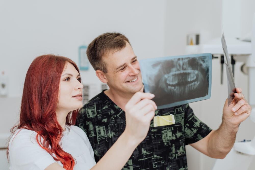 Dentist reviewing patient's x-ray to optimize digital dental care