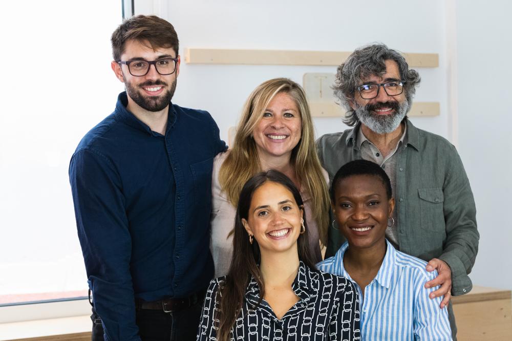Multiracial team of digital marketing professionals at Cloud 7 Agency, smiling together in an office setting, showcasing collaboration and diversity in Seattle's marketing landscape.