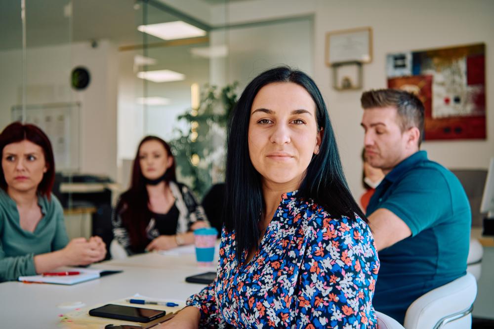 Diverse business team collaborating in a modern office, focusing on strategies for SEO and digital marketing.