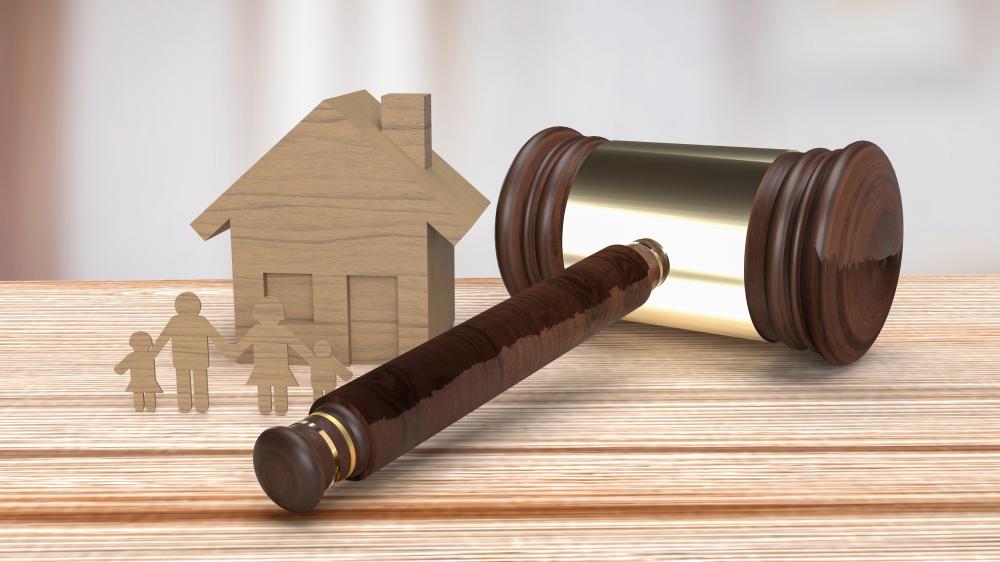Property insurance dispute concept with wooden house and gavel